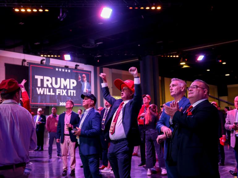 Attendees react as 2024 US Presidential election results are broadcast at the Palm Beach Convention Centre.