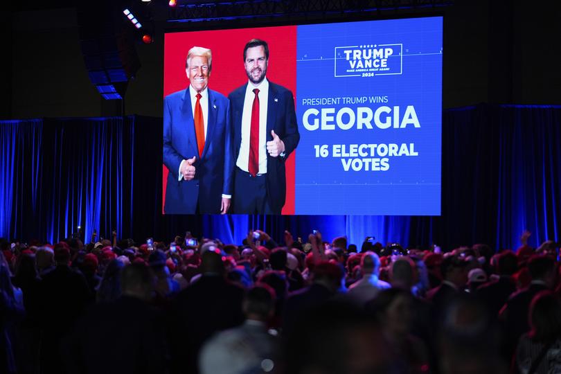 Supporters watch at an election night campaign party for Donald Trump as he won the swing seat of Georgia. (AP Photo/Alex Brandon)