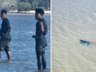 Incredible photos taken on Thursday afternoon show Indonesian fishermen swimming through shallow, croc-infested waters at West Arnhem Land in the Northern Territory to collect sea cucumbers.