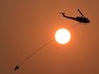 Fire crews and water bombing helicopters continue to battle a blaze northwest of Townsville.