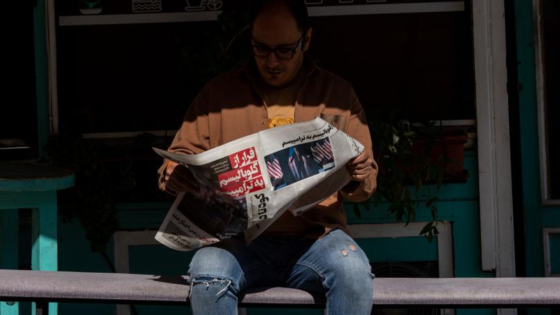 A man in Tehran reads a newspaper story about Donald Trump’s victory in the U.S. presidential election on Thursday, Nov. 7, 2024. Many former officials, pundits and newspaper editorials in Iran have called for the government to engage with Trump in the week since his reelection. (Arash Khamooshi/The New York Times)