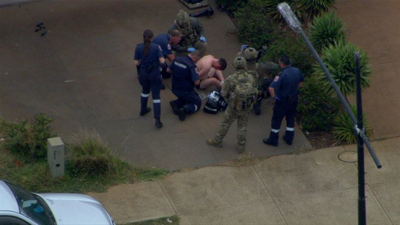 The shirtless gunman was arrested by police at the scene and taken to the Royal Melbourne Hospital.