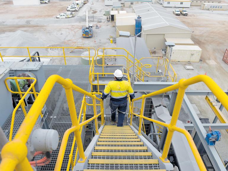 A worker walks down stairs at the Bald Hill treatment plant