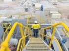 A worker walks down stairs at the Bald Hill treatment plant