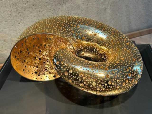 A smaller, golden version called Abundance is being exhibited in the gallery. 