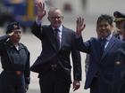 Australian Prime Minister Anthony Albanese and Peruvian Minister of Development and Social Inclusion Julio Demartini wave to the crowd in Lima, Peru.