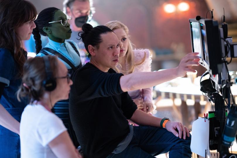 Jon M. Chu on the set of Wicked with Cynthia Erivo and Ariana Grande.