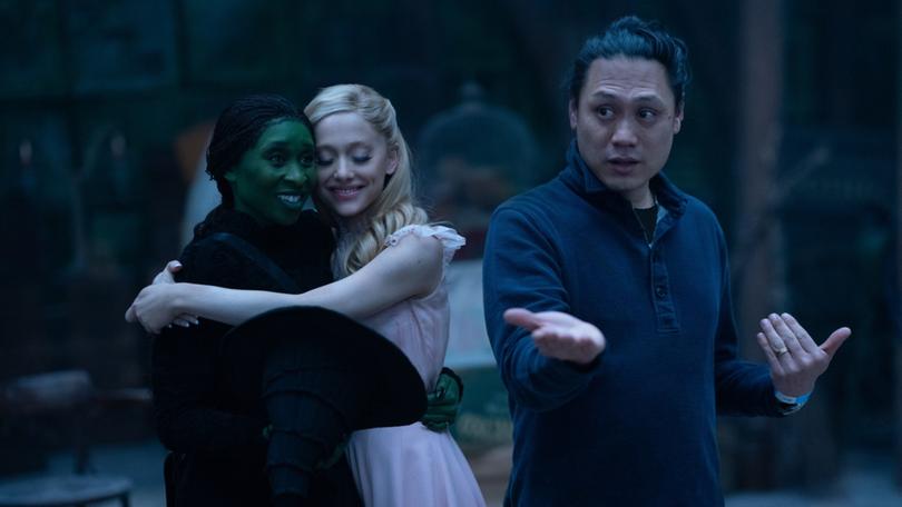 Jon M. Chu on the set of Wicked with Cynthia Erivo and Ariana Grande.