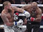 Jake Paul, left, fights Mike Tyson during their heavyweight boxing match, Friday, Nov. 15, 2024, in Arlington, Texas. (AP Photo/Julio Cortez)