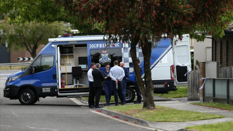 Police at the Melbourne home where a woman was stabbed to death