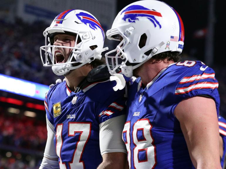 Josh Allen #17 celebrates his rushing touchdown with teammate Dawson Knox.