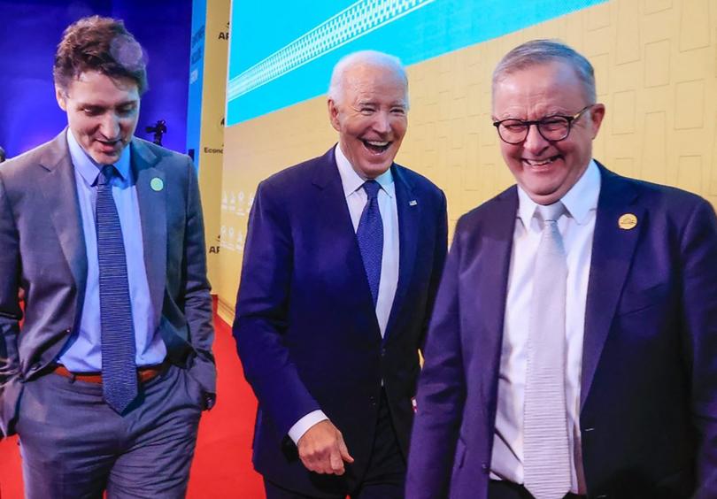 This handout picture released by the Peruvian news agency Andina shows US President Joe Biden (C), Canada's Prime Minster Justin Trudeau and Australian Prime Minister Anthony Albanese smiling during the APEC Summit at the Convention Centre in Lima, on November 15, 2024. (Photo by Handout / ANDINA / AFP) / RESTRICTED TO EDITORIAL USE - MANDATORY CREDIT "AFP PHOTO / ANDINA " - NO MARKETING - NO ADVERTISING CAMPAIGNS - DISTRIBUTED AS A SERVICE TO CLIENTS