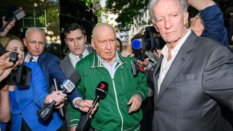 Alan Jones was silent when he left a police station on Monday after being charged with 24 offences.