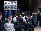 Elsa Wu, the foster mother of one of the defendants Hendrick Lui, holds a banner in protest while leaving the West Kowloon Court following a sentencing hearing for 45 pro-democracy activists in Hong Kong, China, on Tuesday, Nov. 19, 2024. 