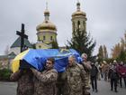 Members of the honor guard carry the coffin of a Ukrainian soldier who was killed during fighting with Russian forces 