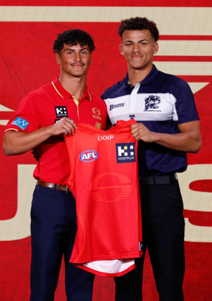 Leo Lombard is presented with his Gold Coast jumper by Jake Rogers.