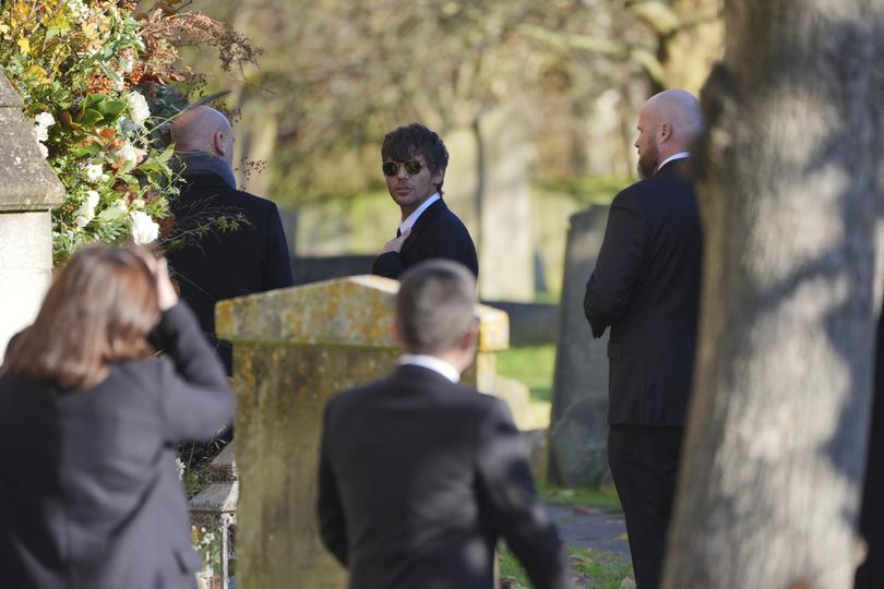 Louis Tomlinson shielded his eyes with sunglasses as he entered the Amersham church.