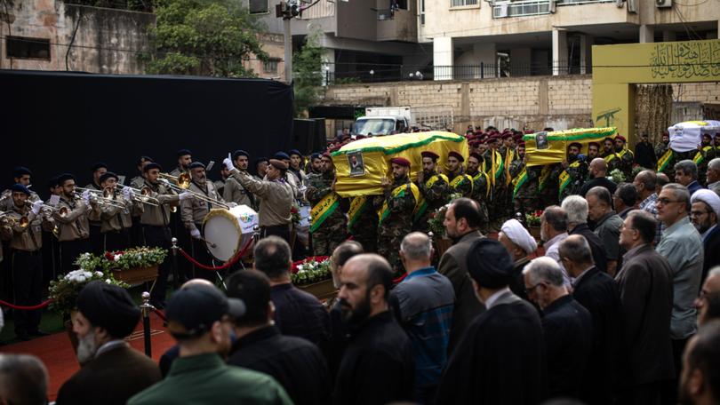 Mourners walk with a coffin during a funeral for four people killed in the pager attack, in Beirut, on Wednesday, September 18, 2024.