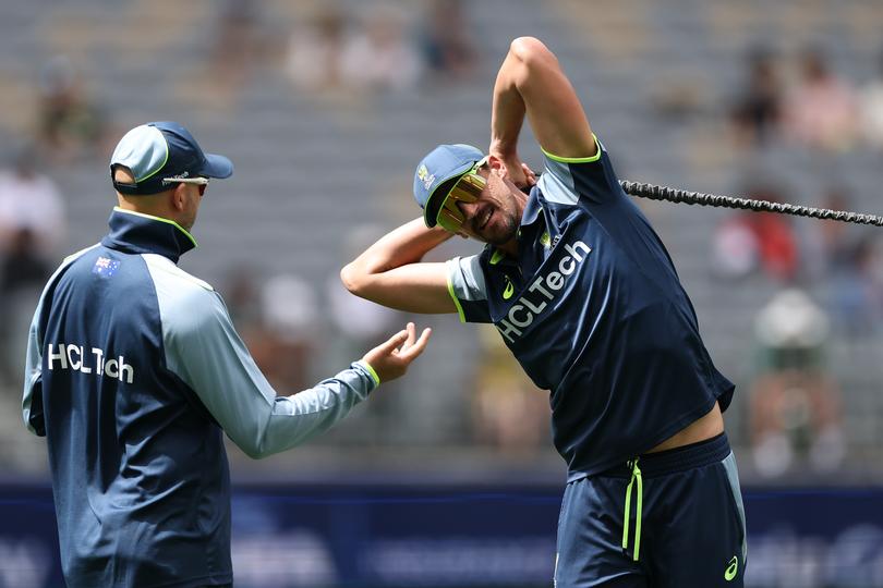 Mitchell Starc warming up alongside Nathan Lyon.