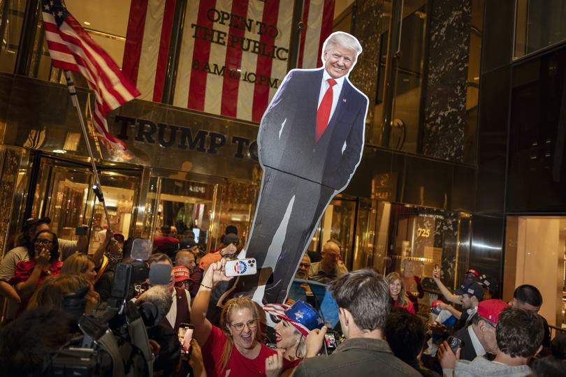 Supporters of former President Donald Trump, then the Republican nominee for president, cheer as they gather outside Trump Tower in Manhattan in the early hours of election day morning. 