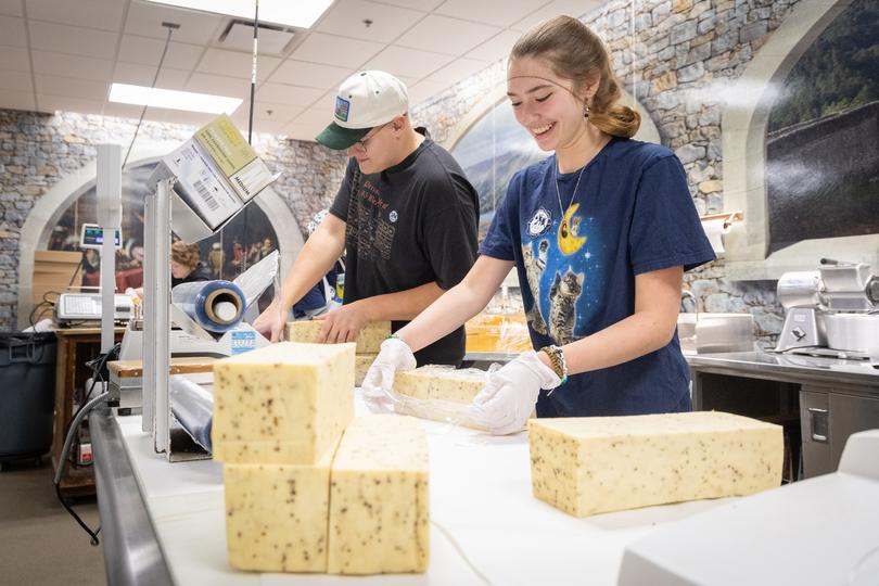 Jackson Humulock and Sasha Stronczek wrap cheeses.