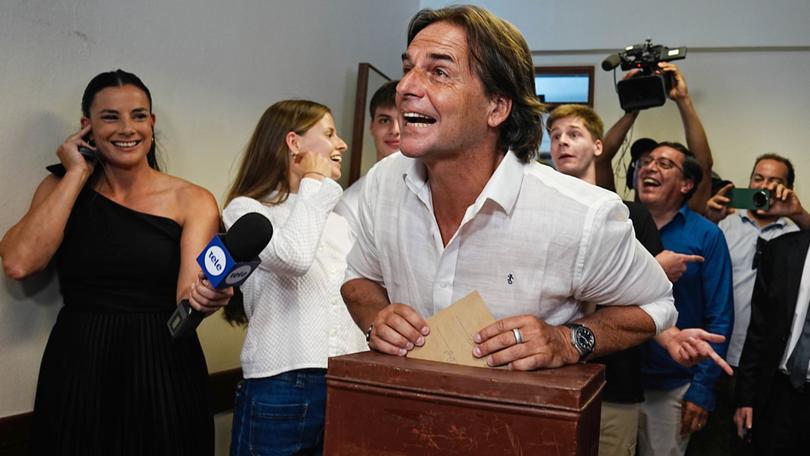 Uruguayan President Luis Lacalle Pou (C) casts his vote at a polling station during the second round of the presidential elections in Canelones, Uruguay.