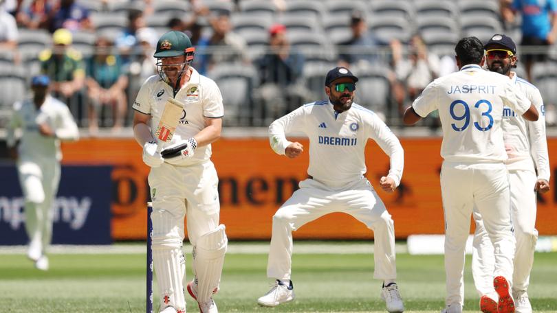 Travis Head walks off the field after being dismissed by Jasprit Bumrah.