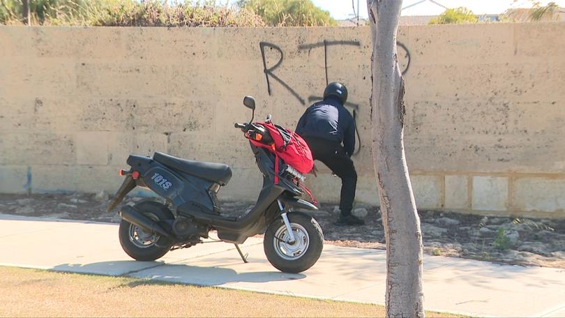 A scooter rider leaves a tribute for Merlin Smith.