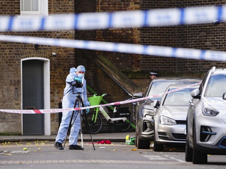 A police forensic officer at the scene on Southern Grove in Ladbroke Grove after a man and an eight-year-old girl were injured in an incident in west London, Monday, Nov. 25, 2024. (Aaron Chown/PA via AP)