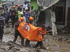 Rescuers carry the body of a victim of flooding in Karo, North Sumatra. 