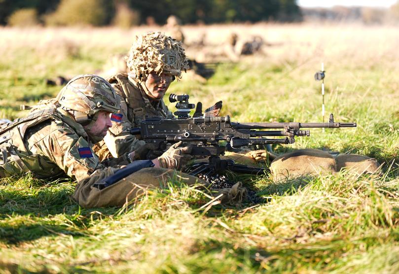 Prince William, Prince of Wales, Colonel of the Welsh Guards, left, with a general-purpose machine gun (GPMG) during a visit to the 1st Battalion Welsh Guards.