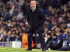 Manchester City manager Pep Guardiola shouts encouragement to his team from the sidelines.