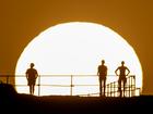 People watch as the sun rises over Ben Buckler Point in Bondi on November 27. A severe heatwave warning has been issued by the Bureau of Meteorology for parts of eastern NSW over the next few days.