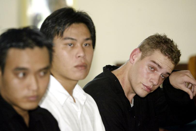 Convicted Australian drug smugglers Matthew Norman, right, gestures as Si Yi Chen, center, and Tan Duc Thanh Nguyen, left, sit in a courtroom during their appeal trial at Denpasar District Court, in Bali, Indonesia, Monday, June, 25, 2007. Norman, Chen and Nguyen, who were sentenced to death, were among a group of nine Australians who were convicted in a plot to smuggle heroin out of the resort island. (AP Photo/Firdia Lisnawati)