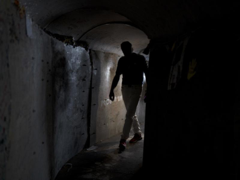 A visitor walks through a replica of a tunnel built by Hamas militants