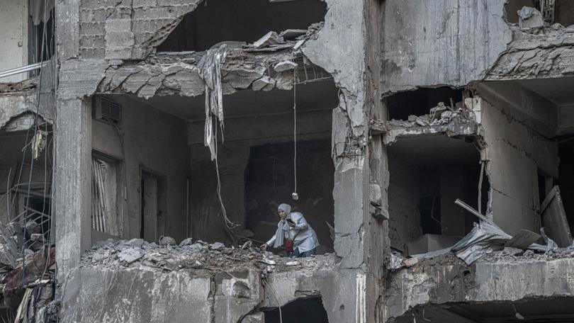 A woman inside a building that was damaged by an Israeli strike in Beirut, the Lebanese capital, on Saturday, Nov. 23, 2024. 