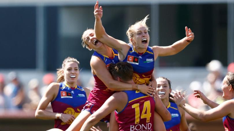 Isabel Dawes and Dakota Davidson celebrate a goal during the AFLW grand final between North Melbourne and Brisbane at Ikon Park. 