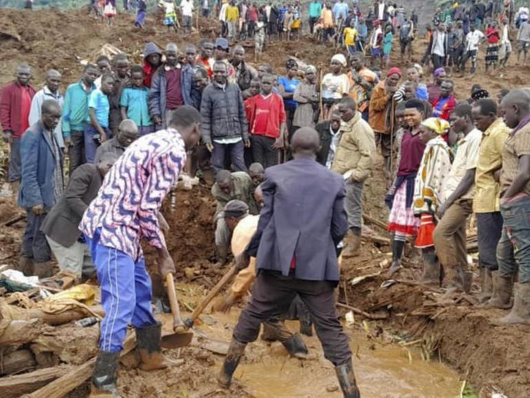 At least 15 people are dead after heavy rain triggered devastating landslides in eastern Uganda. (AP PHOTO)