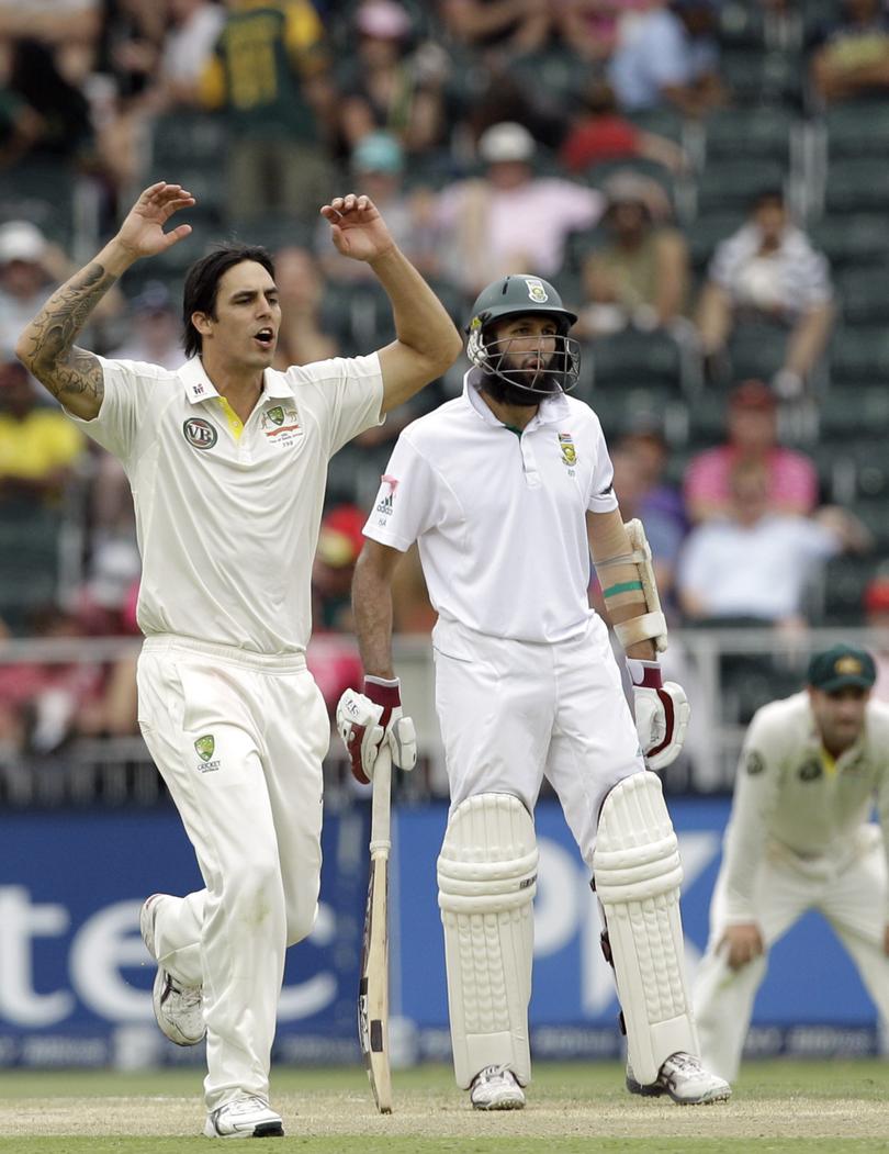 Australia's bowler Mitchell Johnson, left, reacts after his delivery as South Africa's batsman Hashim Amla, right, looks on.