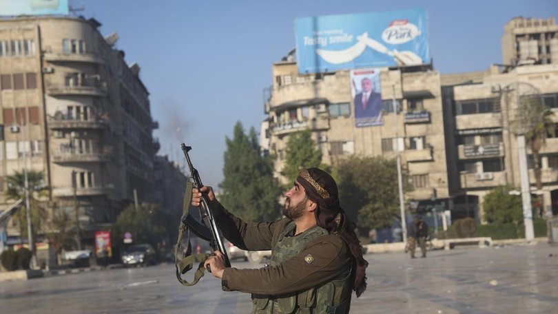 Rebel fighters have gathered in Aleppo's central square after storming the northwestern Syrian city. 