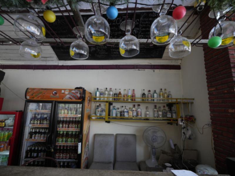 The empty bar of Nana Backpackers hostel in Vang