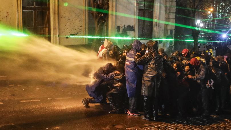 Police use water cannons to disperse Georgian opposition supporters protesting in front of the Parliament building in Tbilisi, Georgia, 01 December 2024. 