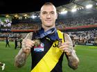 Dustin Martin celebrates with his Norm Smith Medal and Premiership Medal in 2020.