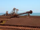 Iron ore stockpiles waiting to be transported at Rio Tinto Group's port facility in Karratha.