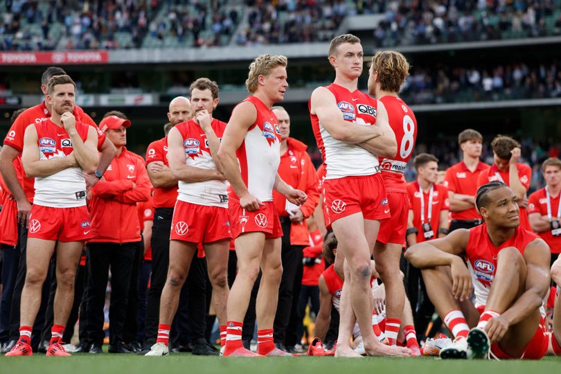 Shattered Swans players after they were humiliated by Brisbane in the grand final.