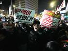 A man shouts outside the National Assembly Building in South Korea to demand President Yoon Suk Yeol steps down. 