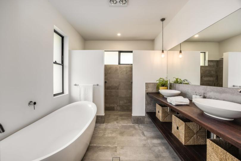 The mansion also features sleek fully-tiled bathrooms and separate laundry.