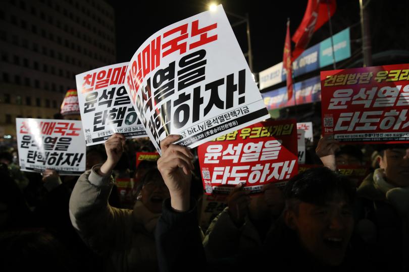 Demonstrators gather in front of the National Assembly after the declaration of martial law by  President Yoon Suk Yeol.