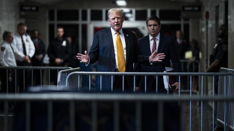 Donald Trump, standing with defense attorney Todd Blanche, speaks at his criminal trial in Manhattan on May 29. 