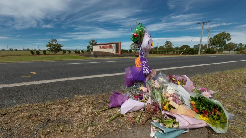 Tributes left at the scene of the fatal multi-car crash in Maryborough, Queensland.